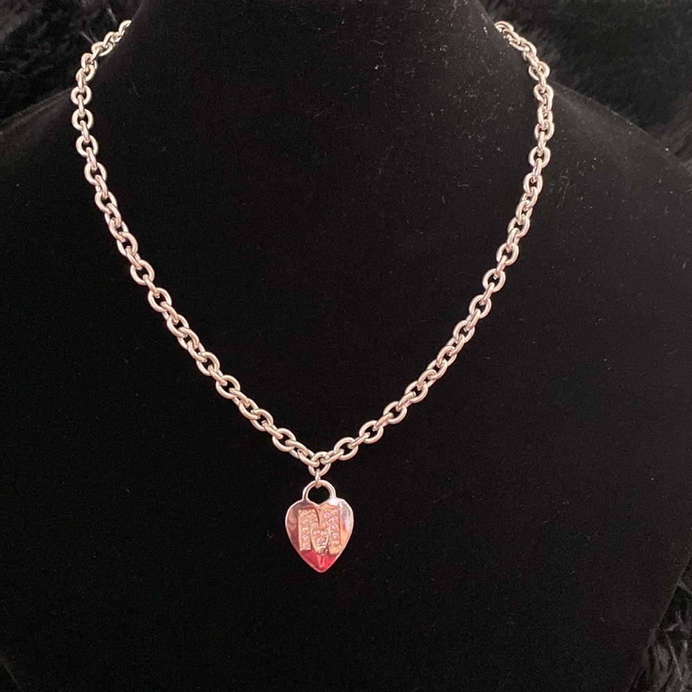 Silver necklace with a heart and the letter M with pink zircons